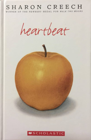 Photo of yellow apple on book cover